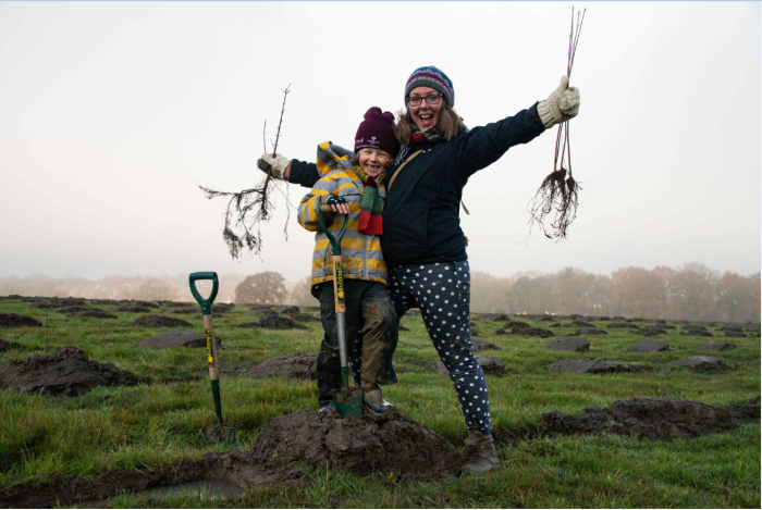 A lady and child tree planting