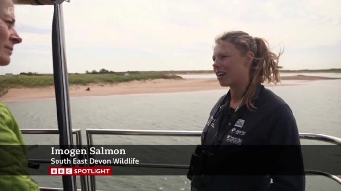 Warden Imo being interviewed by BBC Spotlight on a boat in front of Dawlish Warren sand spit