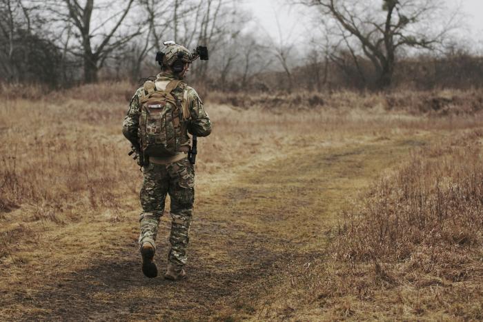 A photo of a soldier on patrol in the countryside