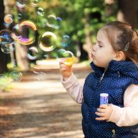Female child blowing bubbles